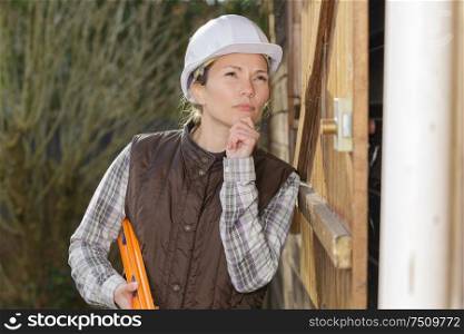 female worker thinking of renovation ideas