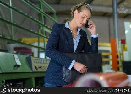 female worker using mobile phone in factory