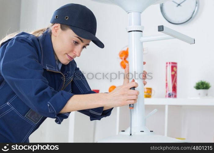 Female worker using screwdriver