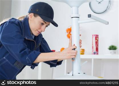 Female worker using screwdriver