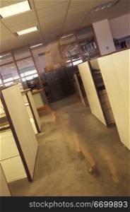Female Worker Walking Through An Empty Office
