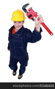 Female worker with an adjustable pipe wrench