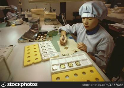 Female worker working on a wristwatch dial, Japan