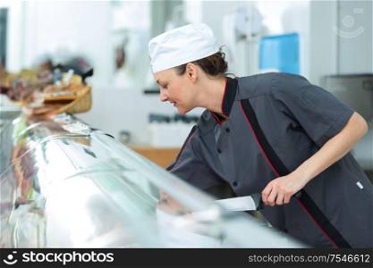 female working in a butchers shop