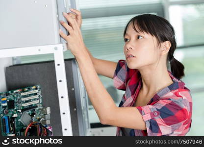 female working in electronic workshop