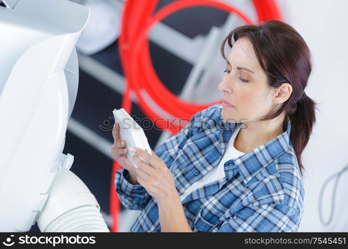 female working on ventilation pipes