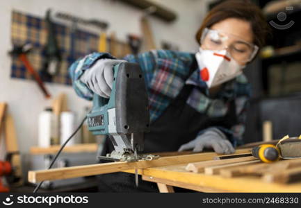 female working workshop with hammer drill
