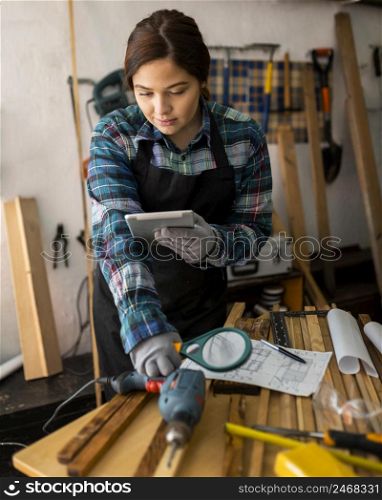 female working workshop with magnifying glass