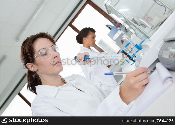 female working writing report in lab