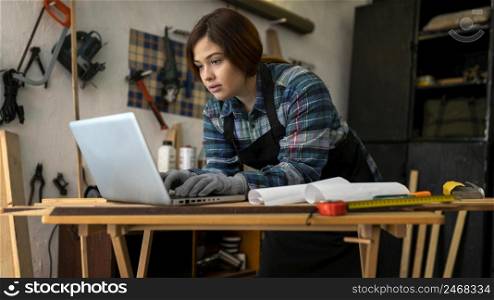 female workshop checking laptop