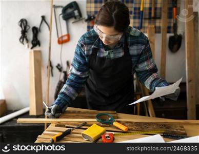 female workshop measure wood plank