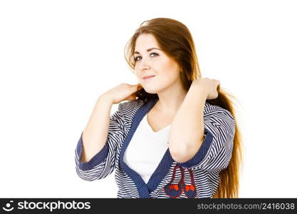 Feminine beauty concept. Portrait of beautiful young woman touching her long brown hair. Young woman touching her long brown hair