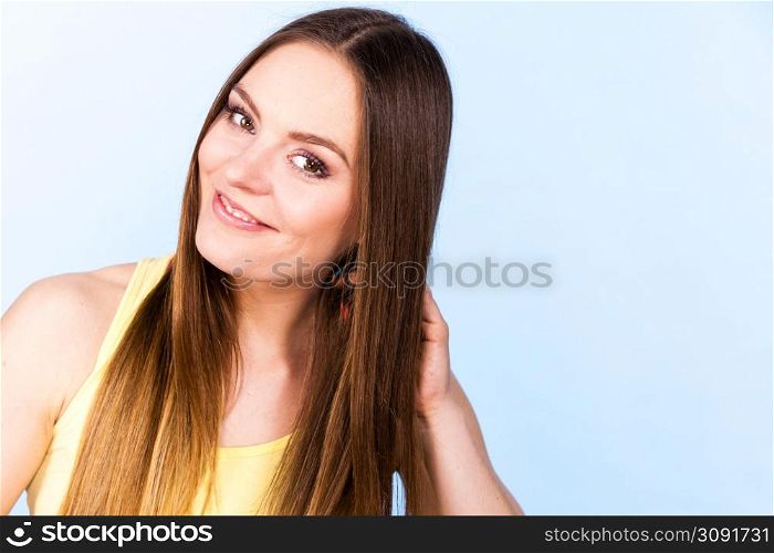 Feminine beauty concept. Portrait of beautiful young woman with long brown hair. Portrait of beautiful young woman with brown hair