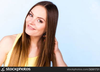 Feminine beauty concept. Portrait of beautiful young woman with long brown hair. Portrait of beautiful young woman with brown hair