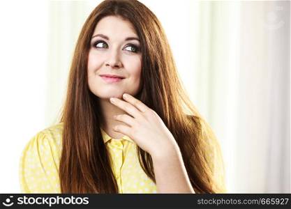 Feminine beauty concept. Portrait of beautiful young woman with long brown hair. Female being positive.. Portrait of beautiful cheerful young woman