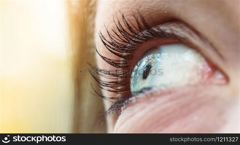 Feminine eye, close up with blue iris and eyelashes