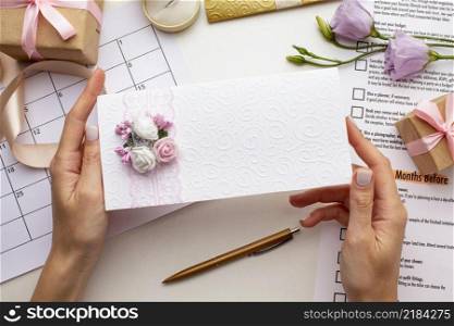 feminine hands holding wedding envelope