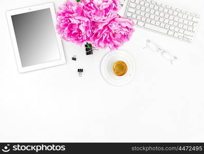 Feminine office workplace with coffee and flowers. Mockup with digital tablet screen