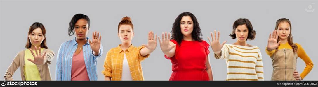 feminism, female rights and protest concept - group of different women making stopping gesture over grey background. group of different women making stopping gesture