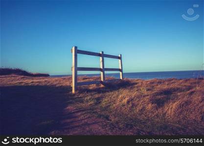 Fence by the sea at sunset