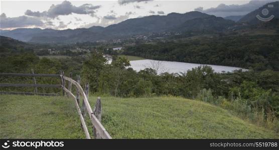 Fence in a field with mountains in the background, Copan, Copan Ruinas, Copan Department, Honduras