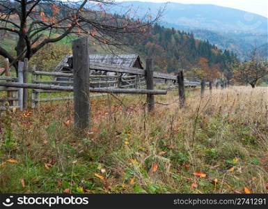Fence of autumn mountain garden near farmstead