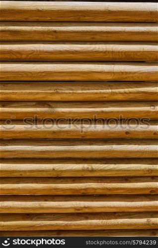 fence of stacked round trunks wood pattern texture background