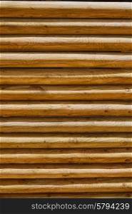 fence of stacked round trunks wood pattern texture background