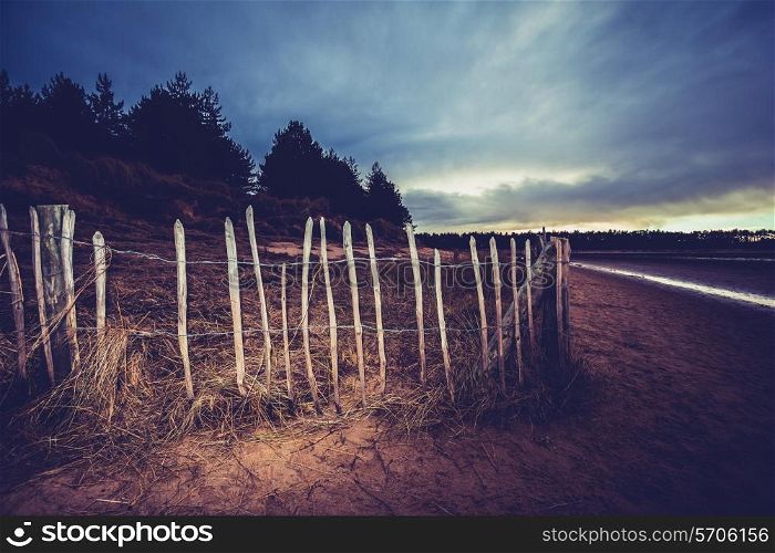 Fence on the beach at night