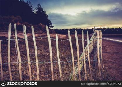 Fence on the beach in the evening
