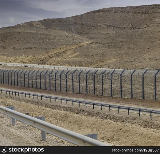 fence on the border in the negev desert between egypth and israel. Israel border with Egypt in the Negev desert