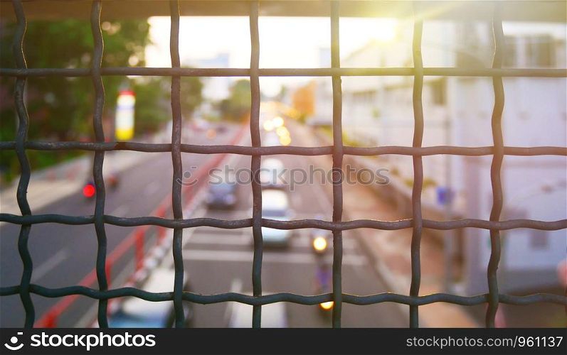 fence with metal grid and sub flare in background