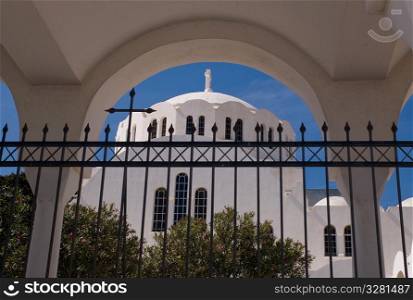 Fence with view of church dome in Santorini Greece
