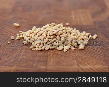 Fenugreek seeds on a brown surface