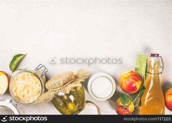 Fermented food, probiotic sources - cucumber pickles, coconut milk yogurt, apple cider vinegar and sauerkraut - copyspace, flat lay