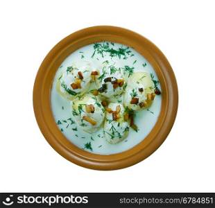 Fermented milk product guslyanka with potatoes and fried bacon. Carpathian cuisine