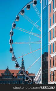 Ferris wheel against the blue sky in the historical part of Gdansk Poland