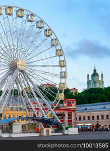 Ferris wheel and Andrew church in the background. Kyiv, Ukraine