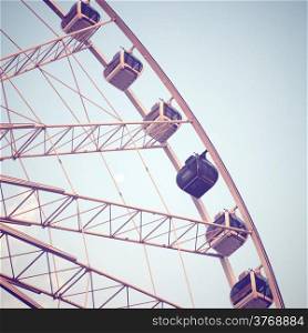 Ferris wheel and blue sky with retro filter effect