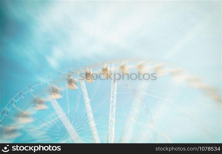 ferris wheel blue sky background. Double exposure