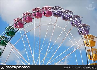 Ferris wheel in a cloudy sky. Attraction in park