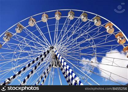 ferris wheel of the amusement park in the blue sky background. Retro colorful ferris wheel of the amusement park in the blue sky background. ferris wheel of the amusement park in the blue sky background. Retro colorful ferris wheel of the amusement park in the blue sky background.