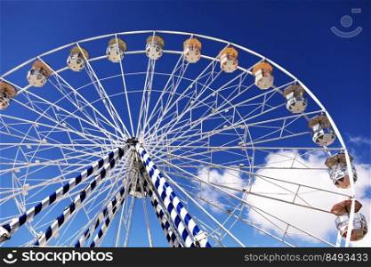 ferris wheel of the amusement park in the blue sky background. Retro colorful ferris wheel of the amusement park in the blue sky background. ferris wheel of the amusement park in the blue sky background. Retro colorful ferris wheel of the amusement park in the blue sky background.