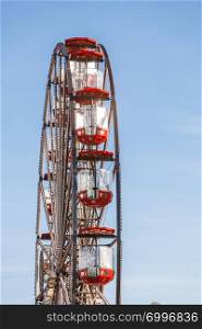 Ferris wheel on blue sky, carousel in amusement park