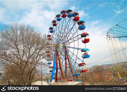 Ferris wheel on the blue sky background