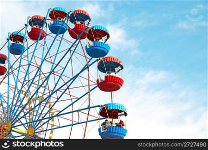 Ferris wheel on the blue sky background