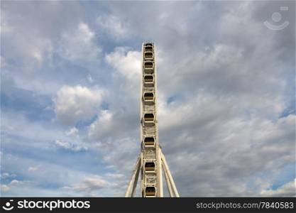 Ferris wheel with blue sky and cloud