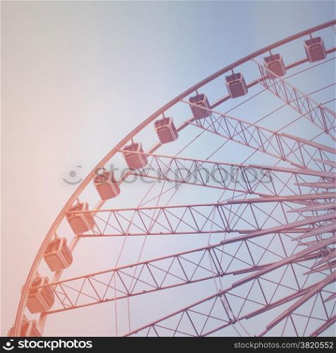 Ferris wheel with blue sky with retro filter effect