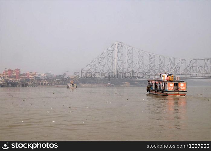 Ferry boat crosses the Hooghly River nearby the Howrah Bridge in Kolkata. To use the ferry is easy, fast and cheap way how to cross the Hooghly River.