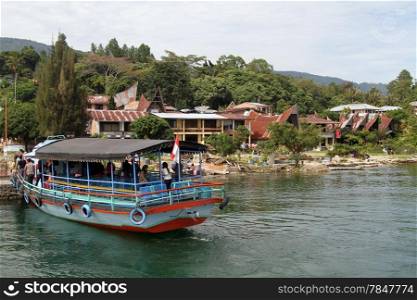 Ferry boat near pier Tuk-tuk of Samosir island, Indonesia